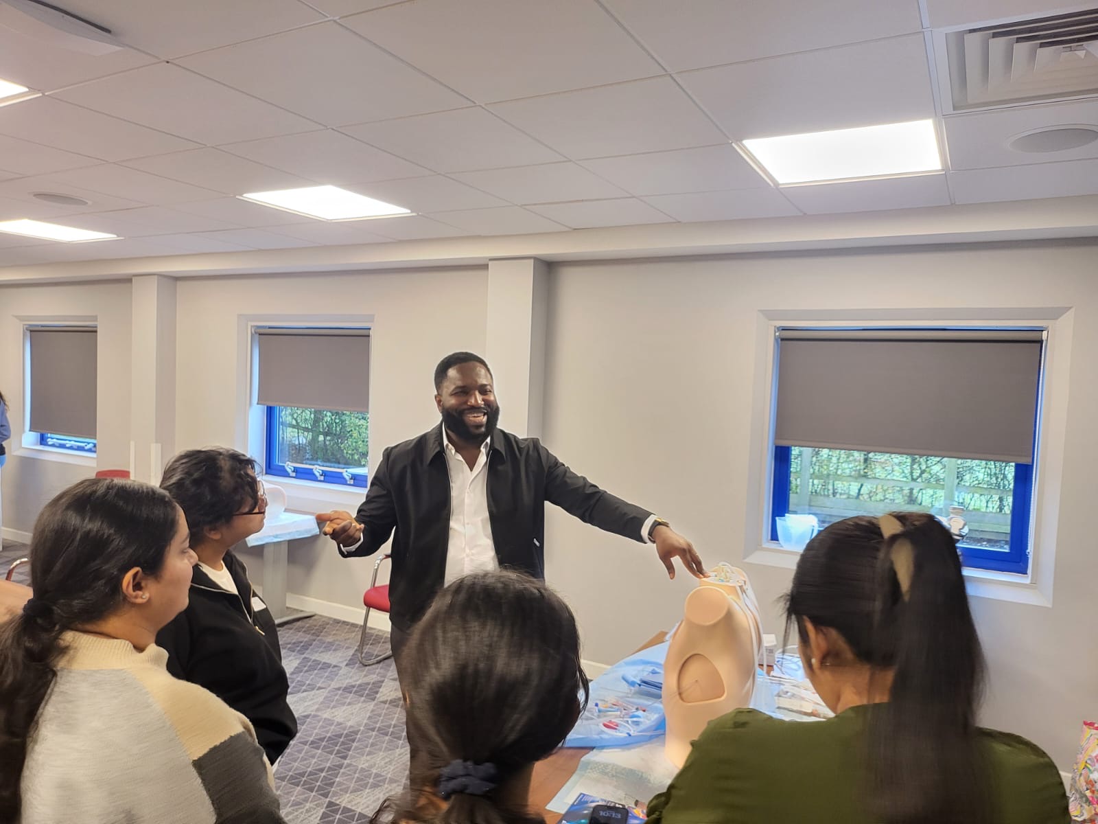 Dr. Joshua Igwe leading a hands-on clinical skills workshop with trainees